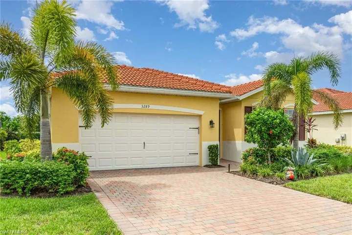 Mediterranean / spanish-style home with stucco siding, decorative driveway, a garage, and a tiled roof