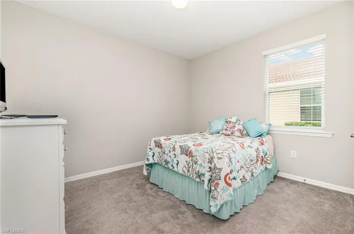 Bedroom featuring baseboards and light colored carpet