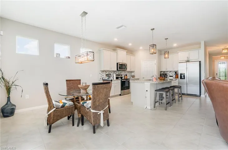 Dining room featuring light tile patterned floors and recessed lighting
