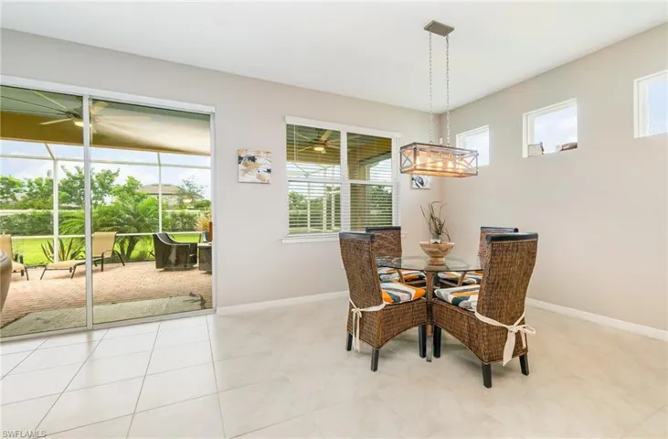 Dining space with light tile patterned floors and baseboards