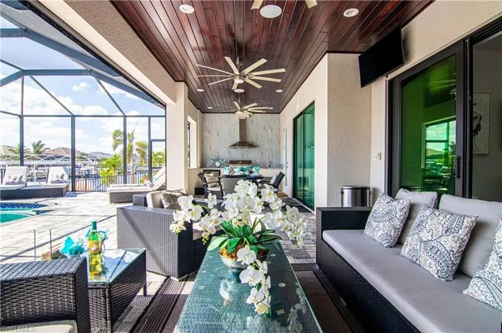 View of patio featuring an outdoor lounge area, ceiling fan, and a lanai