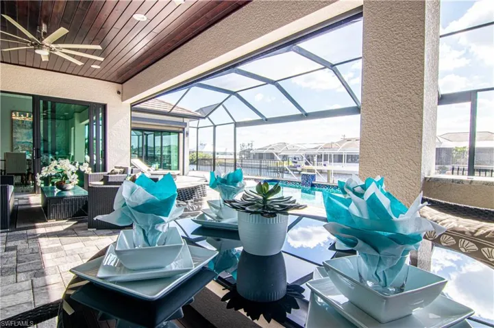 View of patio with a lanai and ceiling fan