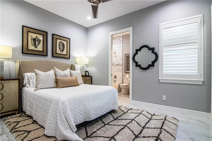 Bedroom with ceiling fan and connected bathroom