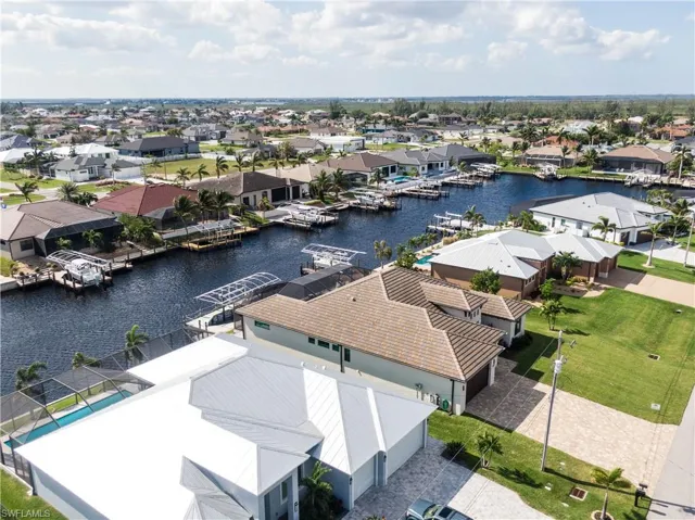 Birds eye view of property with a water view