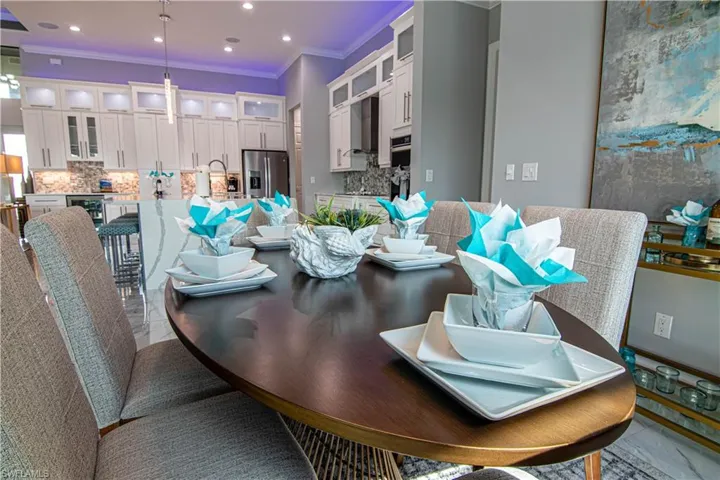 Dining area featuring wine cooler and ornamental molding