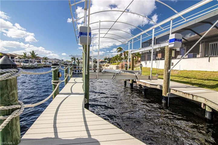 Dock area featuring a lanai and a water view