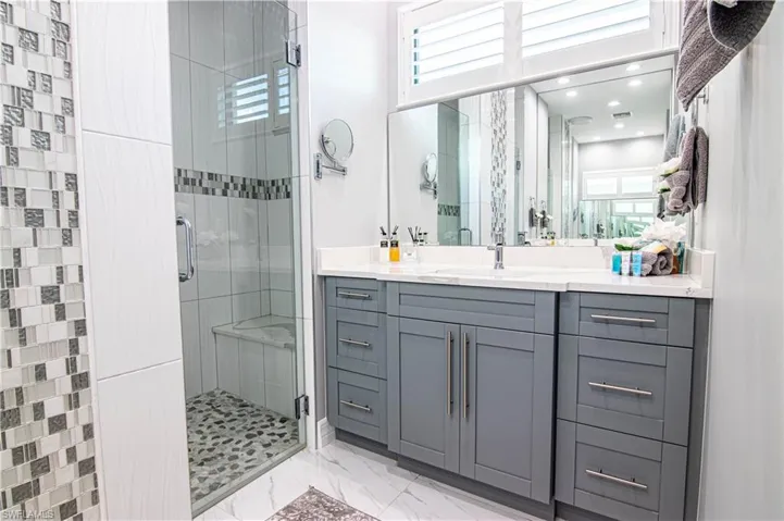 Bathroom featuring vanity and walk in shower