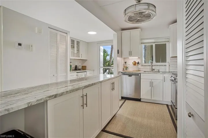 plenty of cabinetry and view of wine/coffee bar