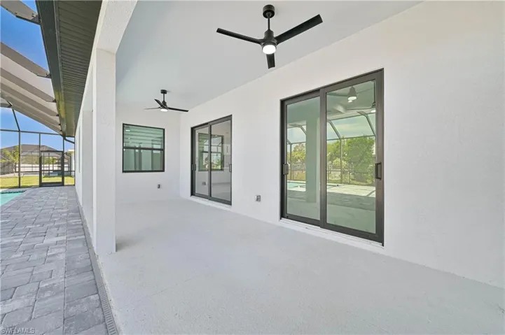 View of patio with a lanai and ceiling fan