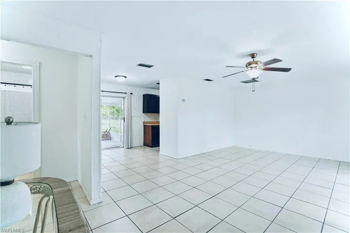 Unfurnished room featuring a ceiling fan and light tile patterned floors