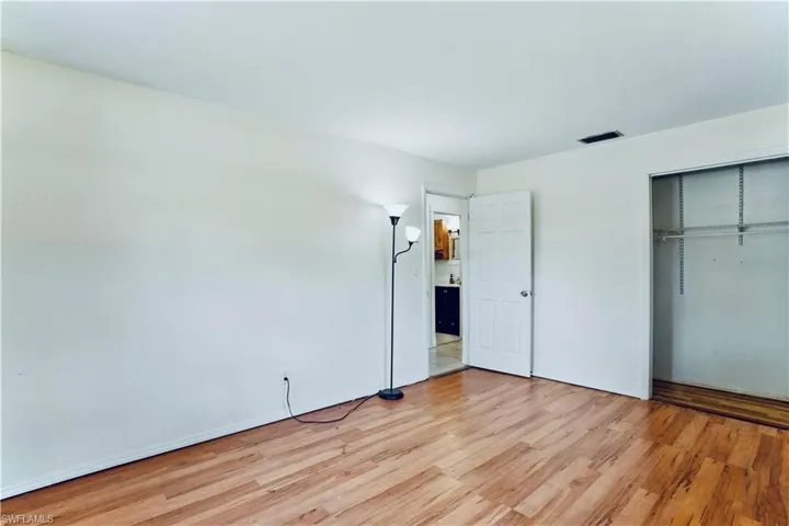 Unfurnished bedroom with light wood-style flooring and a closet