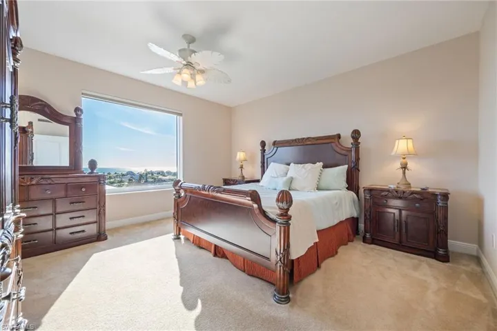 Bedroom featuring light carpet and a ceiling fan