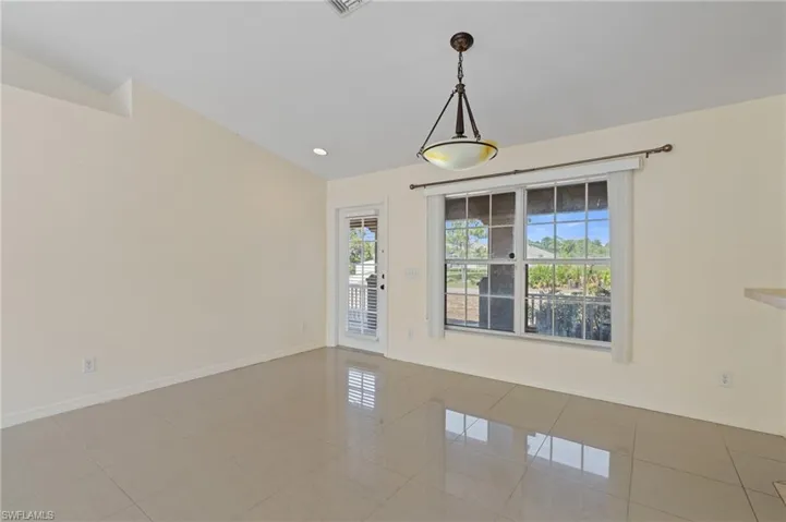 Tiled empty room with vaulted ceiling