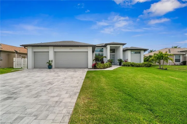 Wide paver driveway + 3-car garage