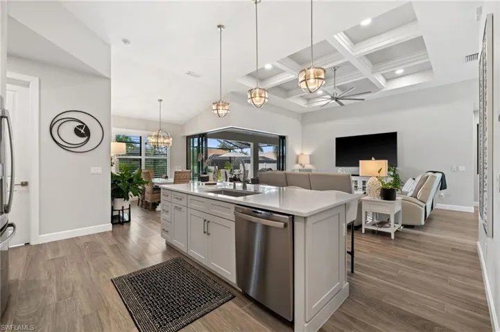 Kitchen island with pendant lighting and breakfast bar
