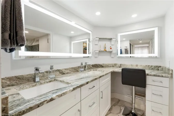 Bathroom featuring tile floors, dual sinks, and oversized vanity