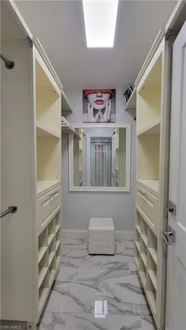 View of spacious custom primary closet