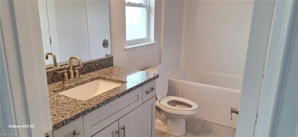 Full bath featuring toilet and vanity