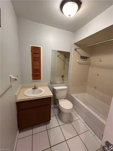 Full bathroom with vanity, light tile patterned floors, and shower / bathtub combination