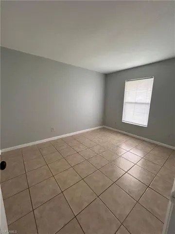 Empty room with light tile patterned floors