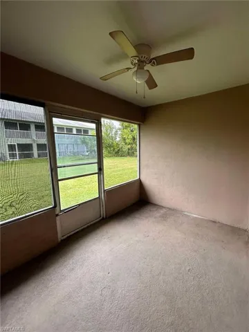 Unfurnished sunroom featuring a ceiling fan