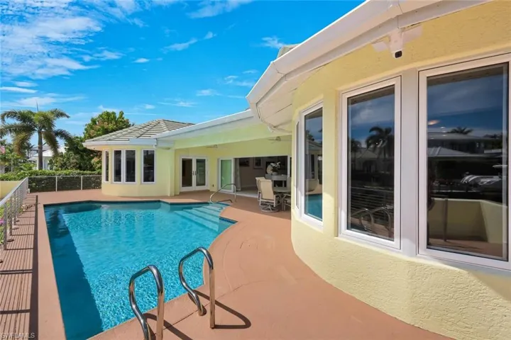 View of pool featuring patio surround and french doors