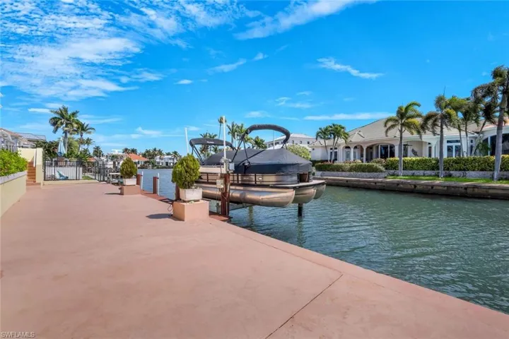 Dock featuring boat lift and a water view