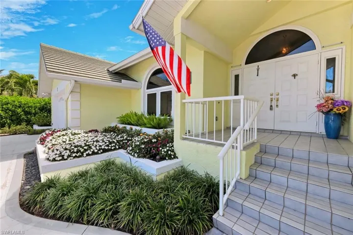 Entrance to property featuring stucco siding and covered porch