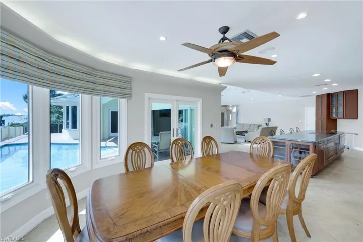 Dining area with recessed lighting, a ceiling fan, and french doors