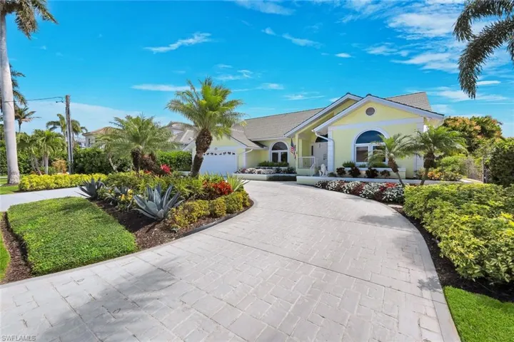 Ranch-style house with driveway, stucco siding, and a garage