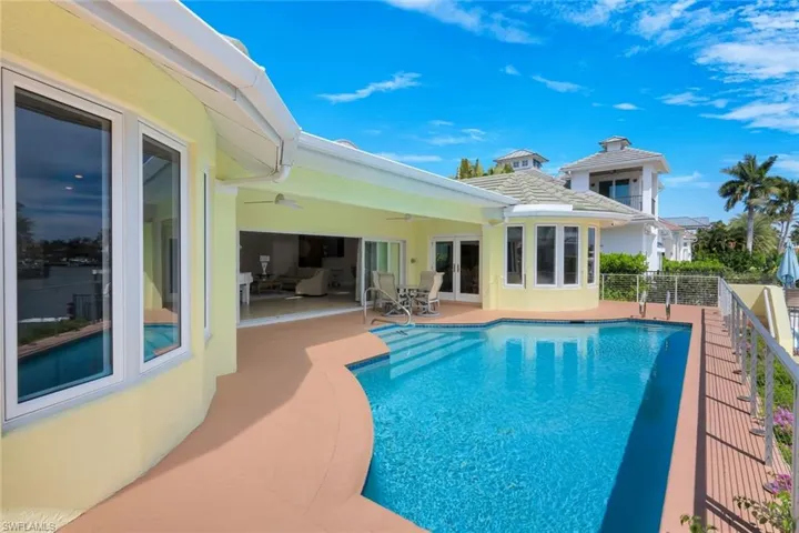 View of swimming pool featuring french doors and patio surround