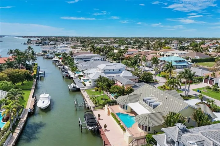 Aerial perspective of suburban area featuring a large body of water