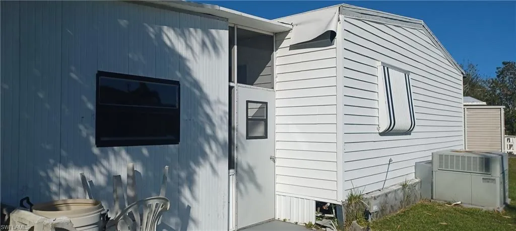 View of side of home featuring central AC unit