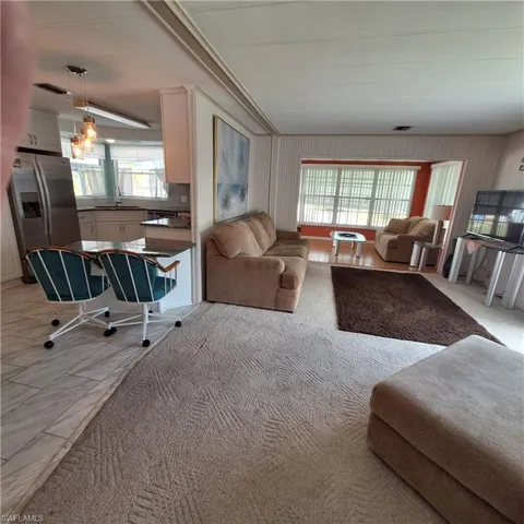 Living room with sink and plenty of natural light