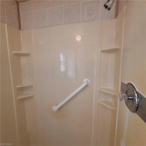 Room details featuring walk in shower