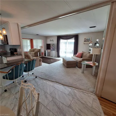Carpeted living room with a wealth of natural light