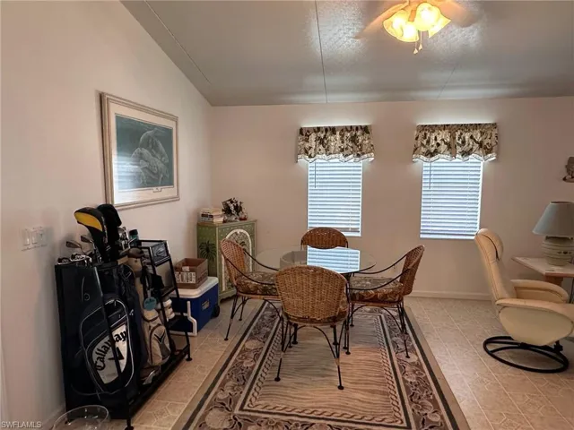 Dining area with light tile patterned flooring and baseboards