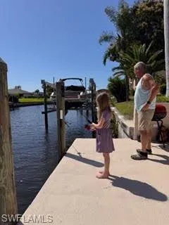 Dock featuring boat lift and a water view