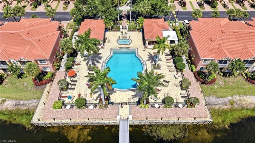 Crystal Clear Pool and Spa with showers, restrooms, lounge chairs, tables and umbrellas