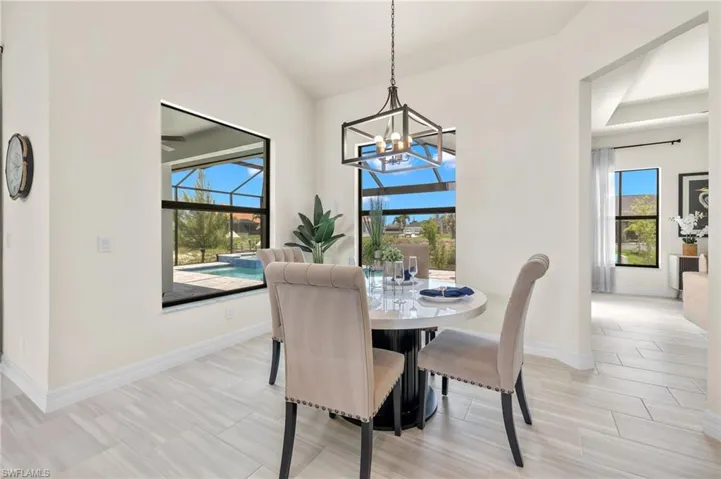 Tiled dining area featuring a notable chandelier