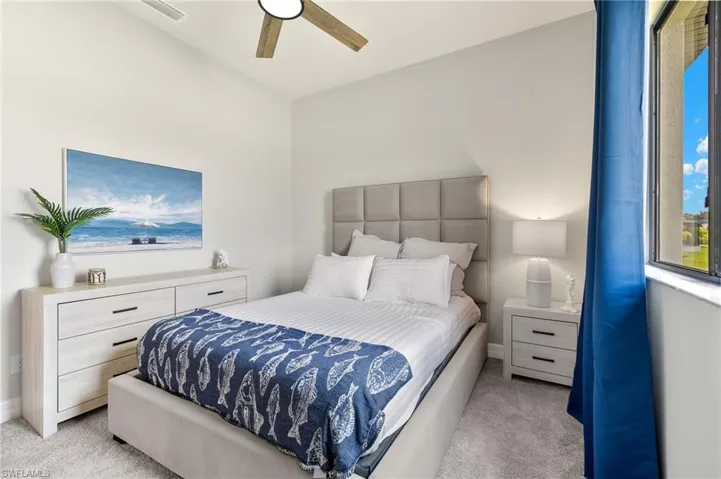 Carpeted bedroom with ceiling fan