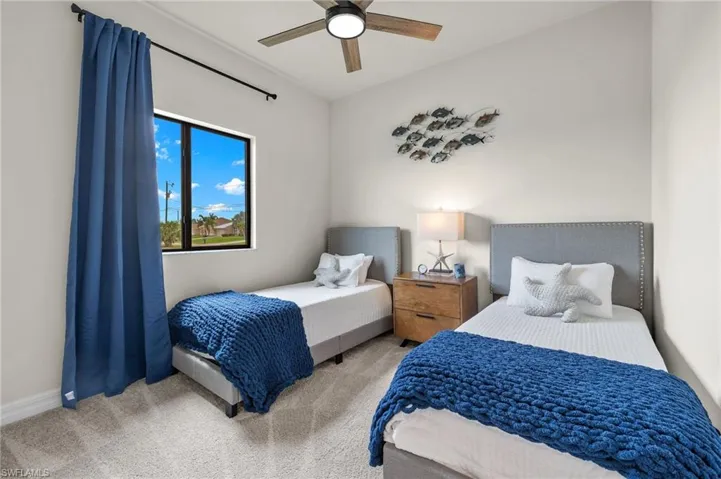 Bedroom featuring carpet and ceiling fan