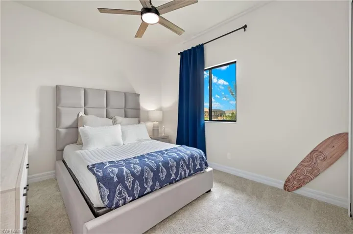 Bedroom featuring carpet and ceiling fan