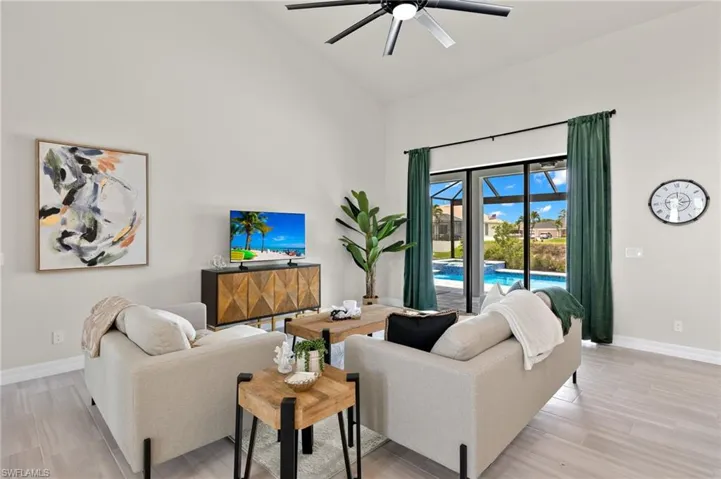 Living room with high vaulted ceiling and ceiling fan