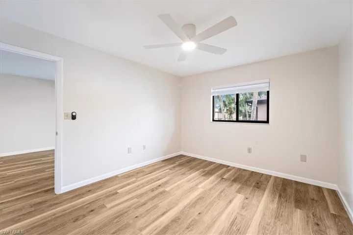 Main bedroom featuring light hardwood / wood-style flooring and ceiling fan