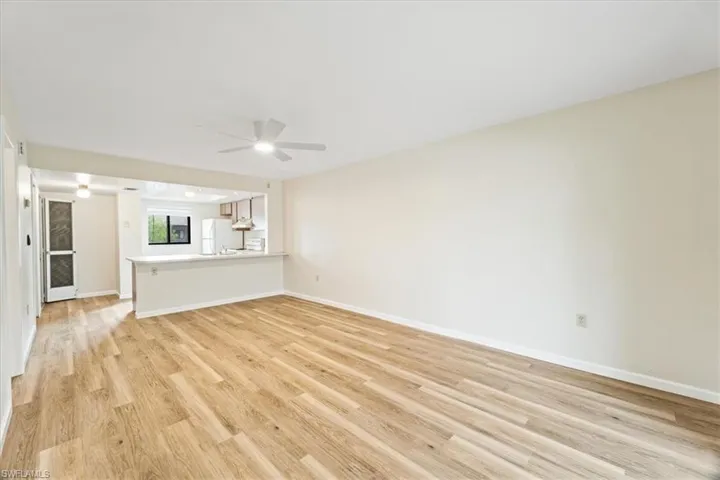 Unfurnished living room with light hardwood / wood-style floors and ceiling fan