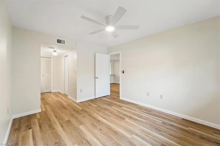 Unfurnished bedroom featuring light hardwood / wood-style flooring, a closet, and ceiling fan