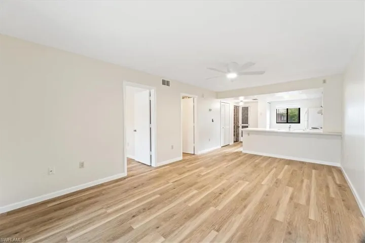Unfurnished living room featuring hardwood / wood-style flooring and ceiling fan