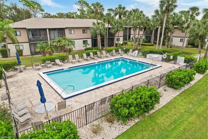 View of swimming pool and landscaped gardens with the condo the background