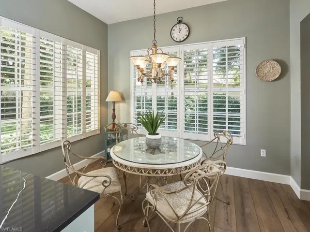 Dining room featuring a chandelier and dark wood-style floors
